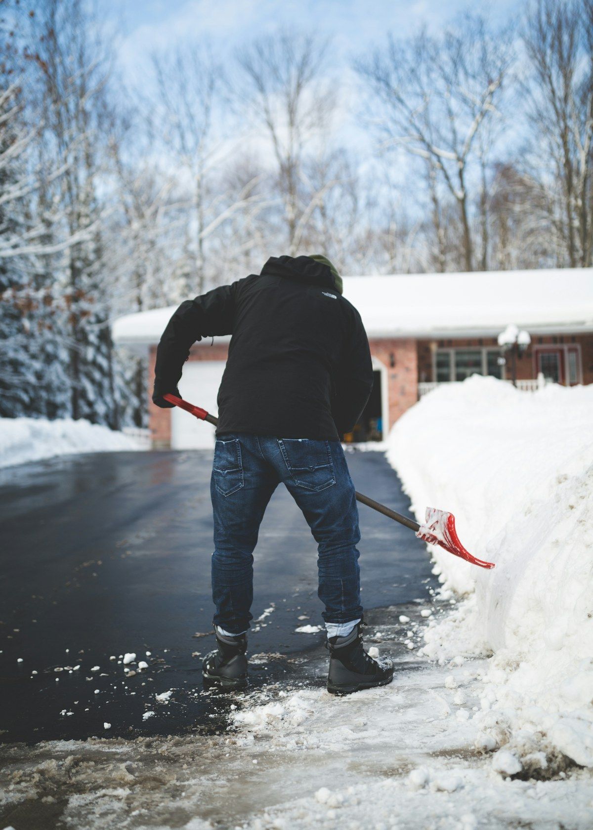 Person shoveling snow from a driveway